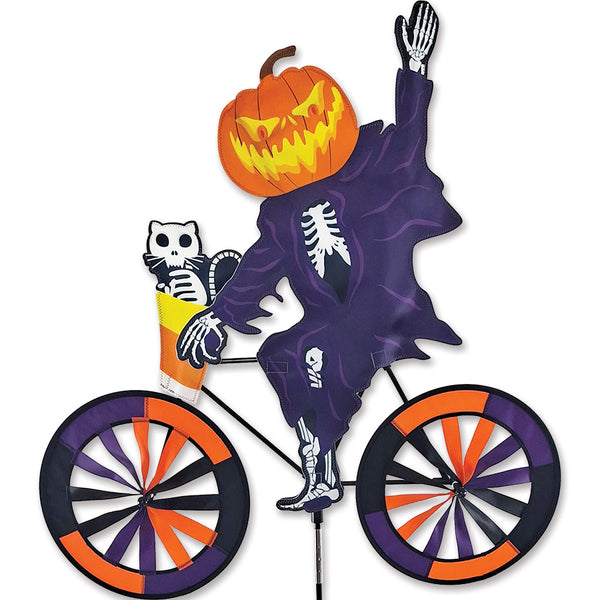 30 in. Bike Spinner - Pumpkin Head Ghost featured on a bike in an outdoor setting, showcasing vibrant colors and whimsical design as it spins.