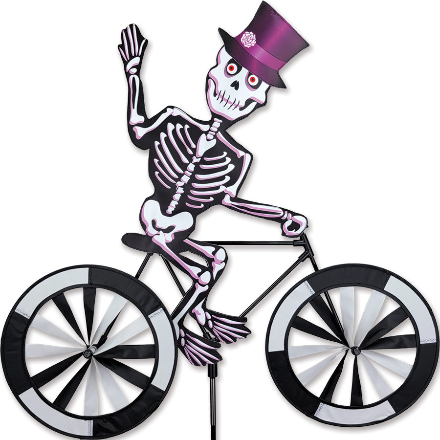 30 in. Bike Spinner featuring a colorful skeleton design, mounted on a bicycle, brightly spinning in the outdoor setting.