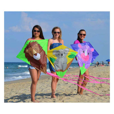 30 in. Diamond Kite - Riley Rhino flying high in the sky, showcasing colorful design and tail against a clear blue backdrop.