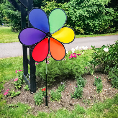 Large 30-inch 6-Petal Rainbow Flower spinner in vibrant colors displayed in a garden setting, spinning gently in the breeze.