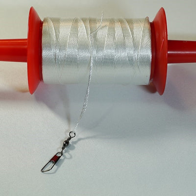 30 LB x 500' twisted kite line on spool, featuring durable twisted polyester, snap swivel, and vibrant colored spools for stylish outdoor flying.