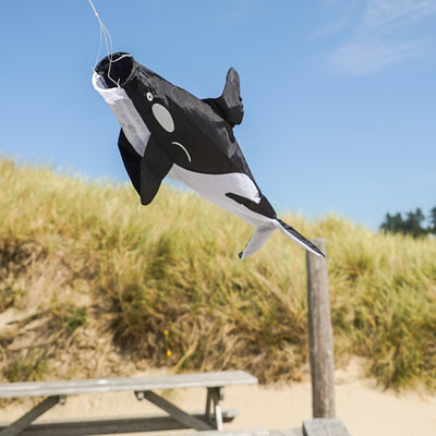 30-inch Orca Windsock featuring a killer whale design, displayed outdoors, swaying gently in the breeze against a clear sky.