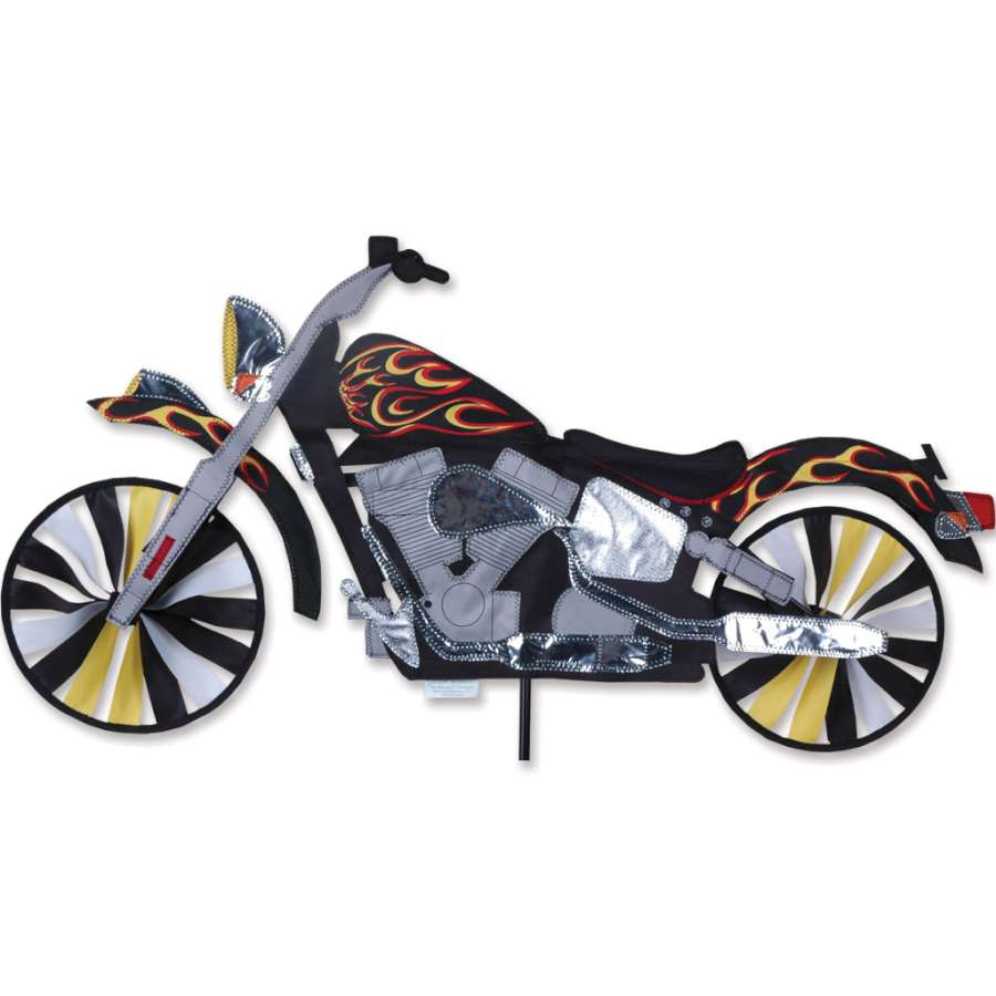 32 in. Motorcycle Spinner with vivid flame design displayed in a garden, showing dynamic motion against the backdrop of flowers and greenery.