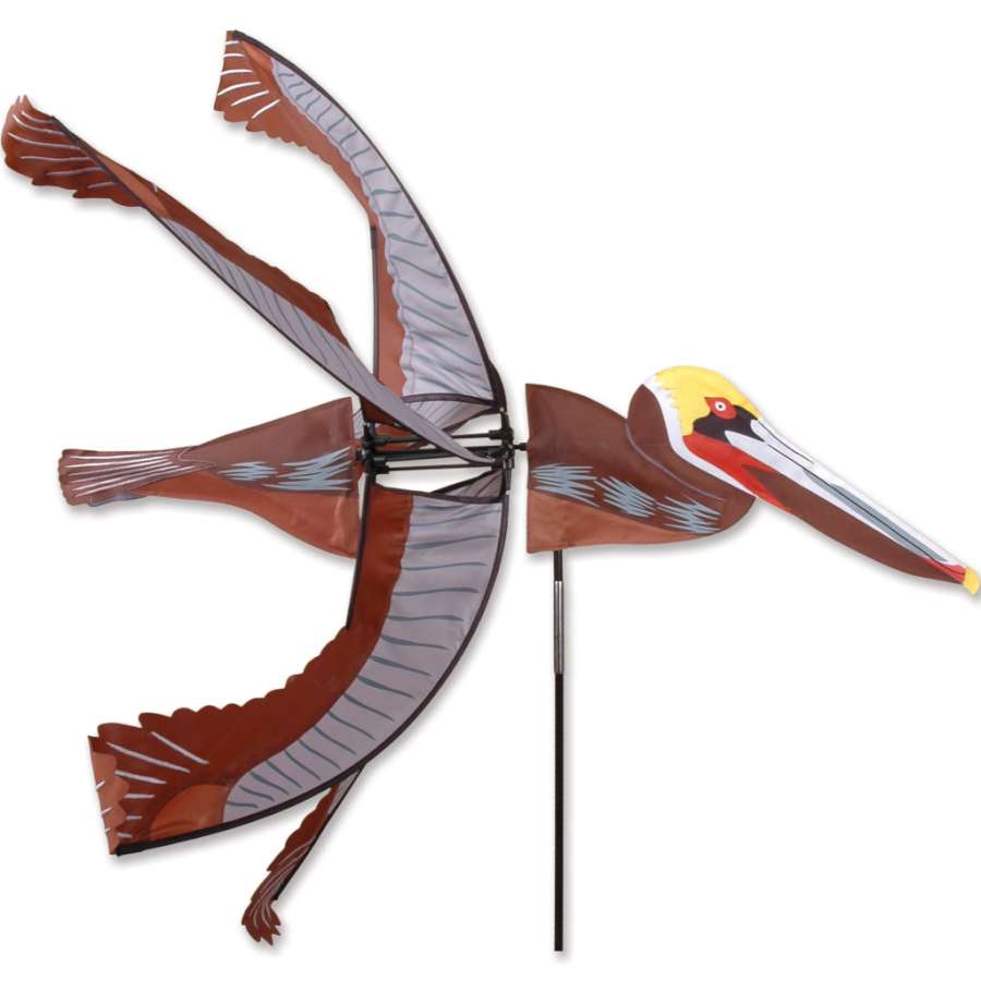 35 in. Brown Pelican Spinner rotating gracefully in an outdoor garden setting, showcasing its vibrant colors and unique design.