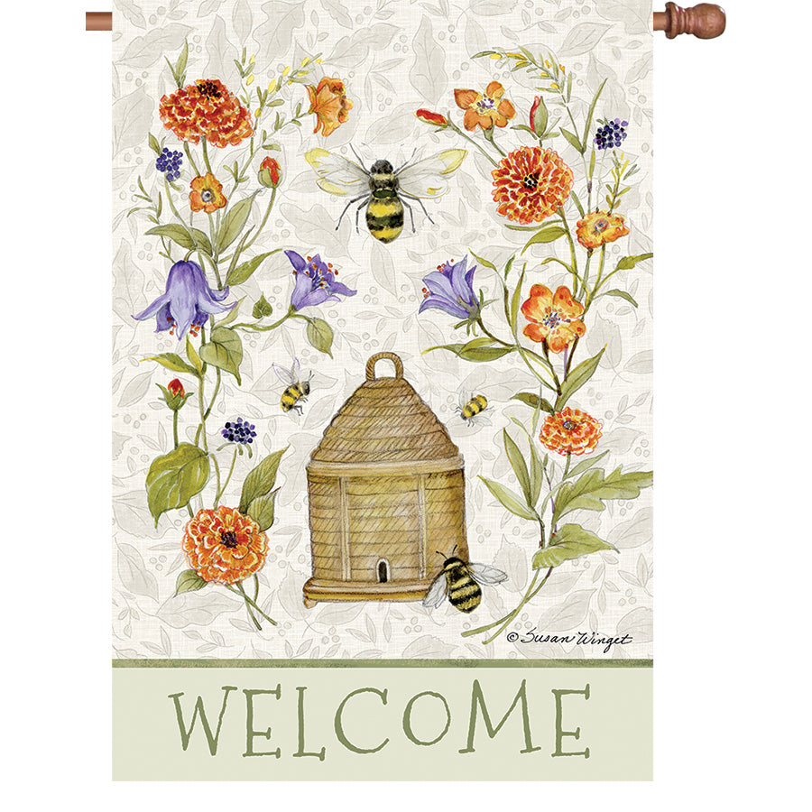 36 in. Elite Oversized House Flag showcasing a bee skep surrounded by colorful flowers, perfectly displayed on a flag pole in a garden setting.