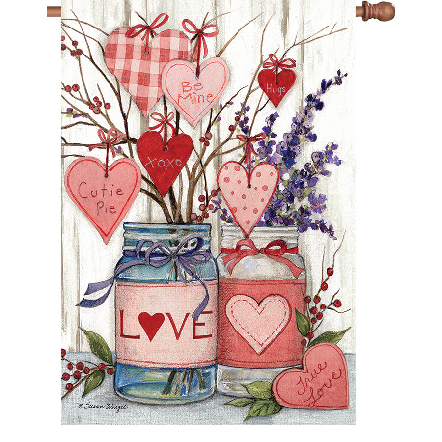 36 in. Elite Oversized House Flag with Valentine Jars design displayed on a flag pole, showcasing vibrant colors and seasonal decorations in a garden setting.