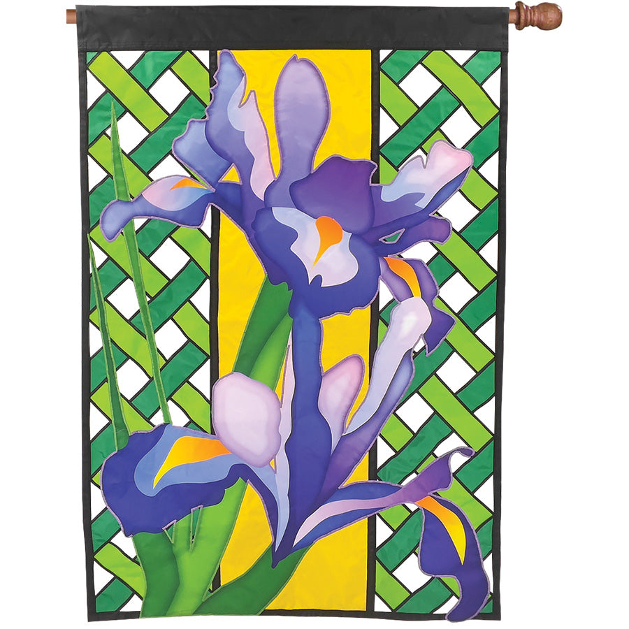 36 in. Elite Oversized Lattice Flag displaying a vibrant iris design, elegantly fluttering on a flag pole in a garden setting.