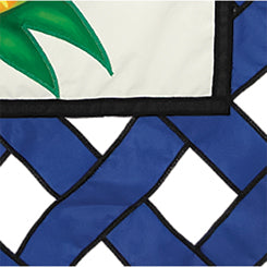 36 in. Elite Oversized Lattice Flag featuring a colorful pineapple design, gracefully displayed outside on a flag pole in a sunny garden setting.