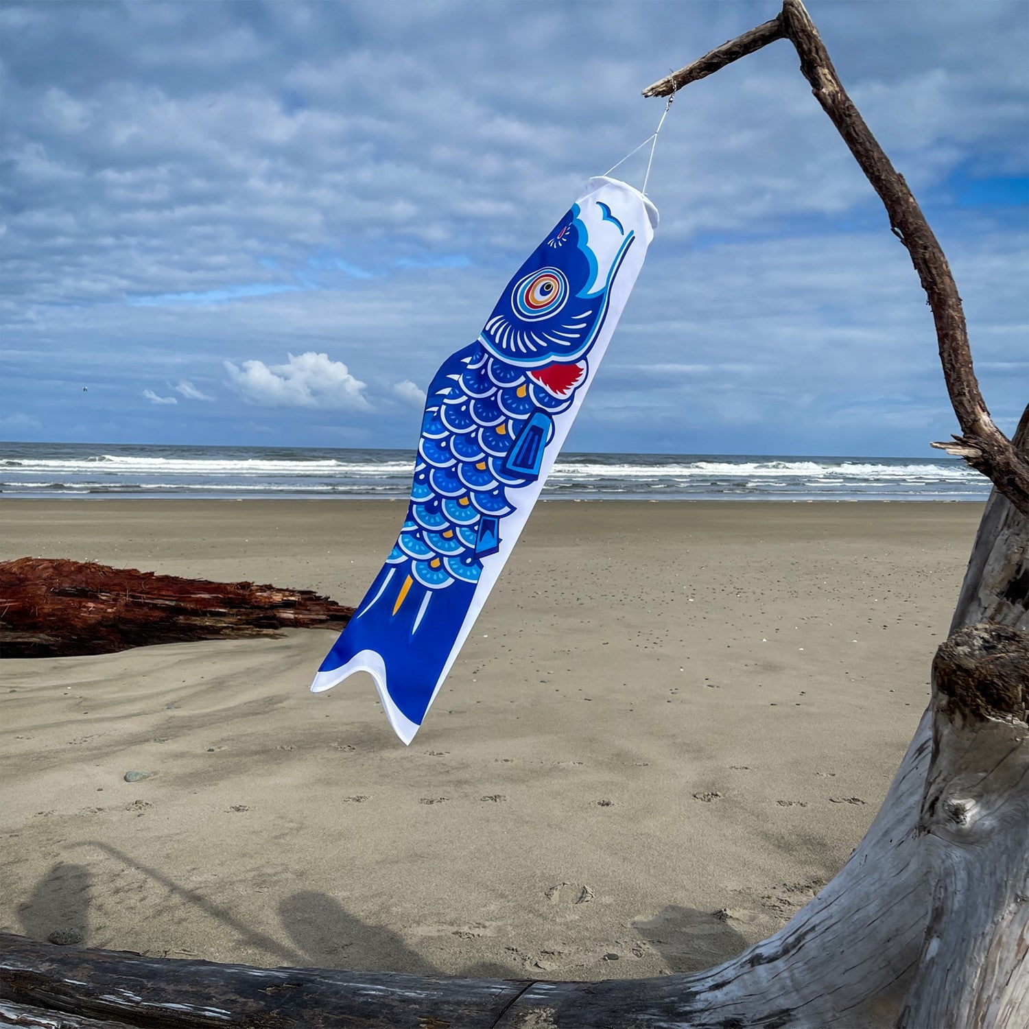 36-inch Blue Koi windsock featuring a colorful Koi fish design hanging gracefully in an outdoor garden setting.