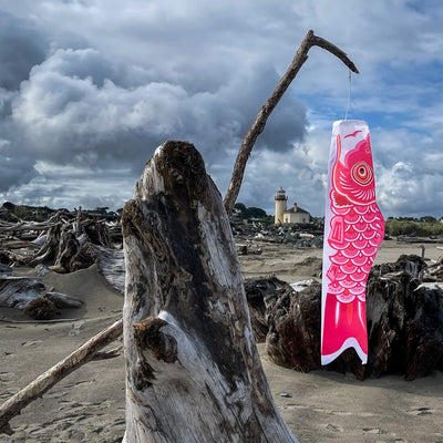 36-inch Pink Koi windsock displaying bright colors in a garden, fluttering gently in the breeze, designed for outdoor decoration and celebrations.