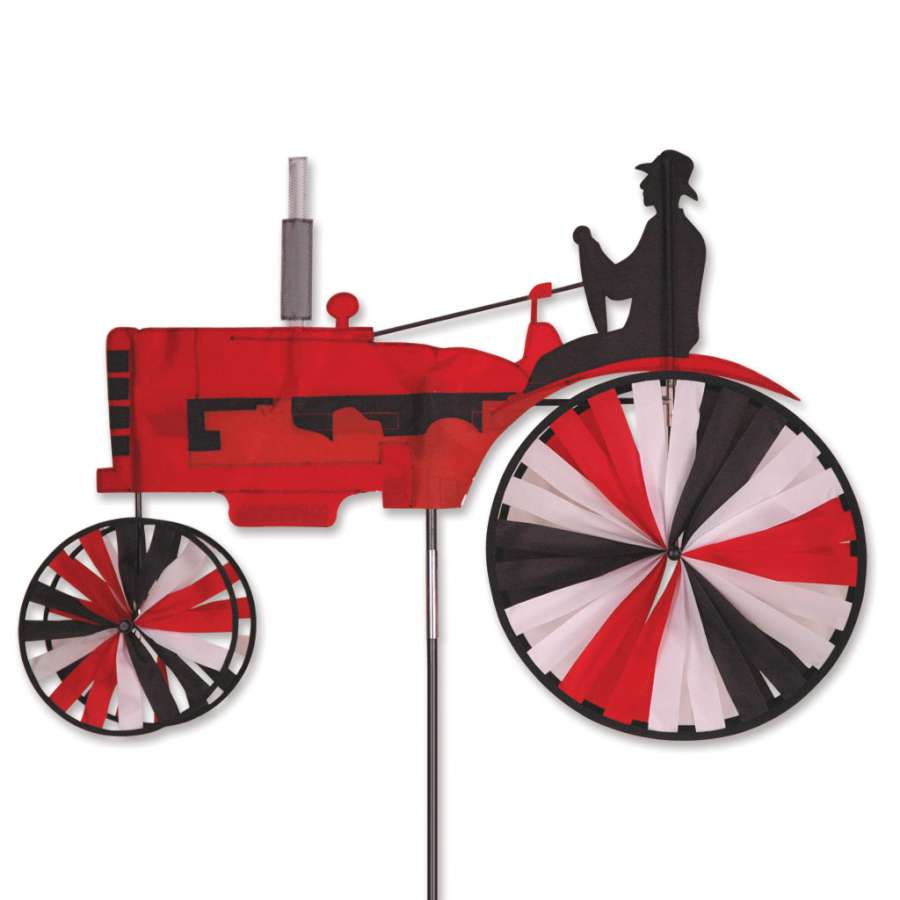38 in. Tractor Spinner in bright red featuring a rustic tractor design spinning gently in an outdoor garden setting.