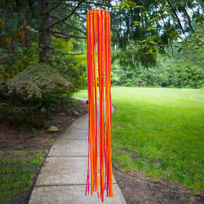 39-inch Sunset Ribbon Windsock featuring vibrant satin ribbons in fuchsia, orange, and yellow displayed outdoors, swaying gently in the wind.