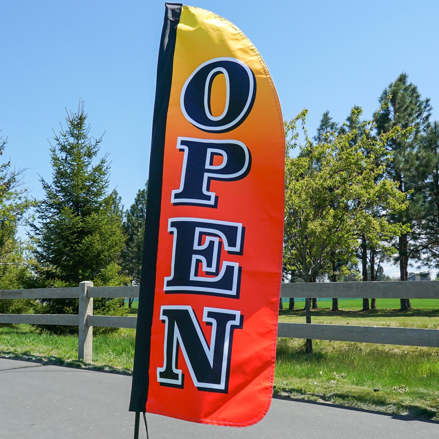 4-foot Heavy Duty Open Gradient Double Sided Feather Banner displayed outdoors, featuring vibrant rainbow colors and 'open' signage in an event setting.