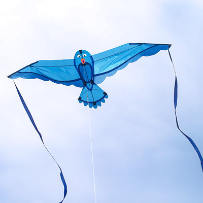 40-inch Blue Bitty Bird Kite featuring a colorful design with attached streamer tails soaring in a clear blue sky.