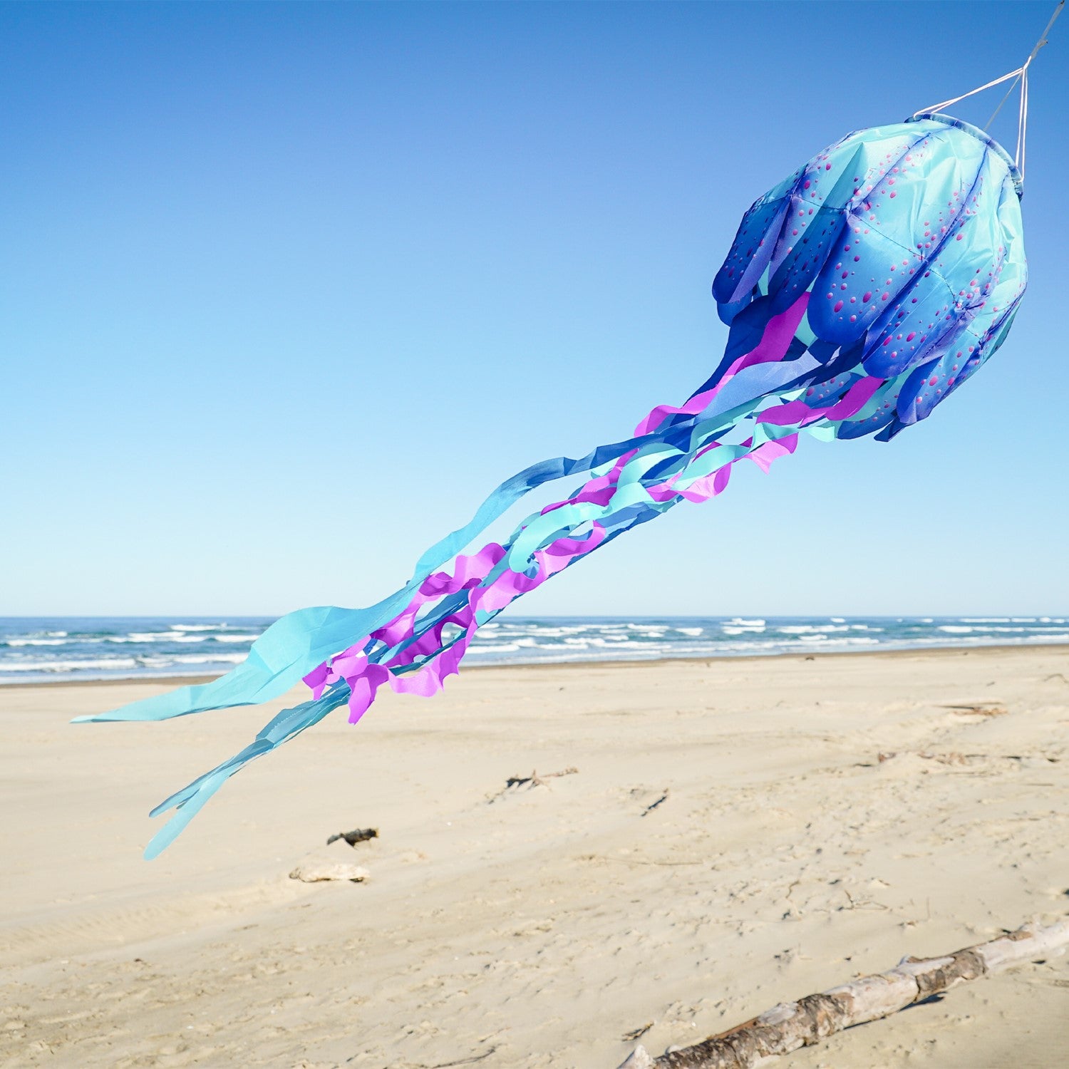 The 40" Blue Jellyfish 3D Windsock features detailed jellyfish design with vibrant colors, dancing in the wind for a whimsical outdoor effect.