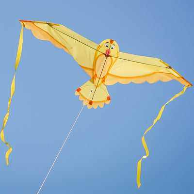 40-inch Yellow Bitty Bird Kite soaring in the sky with color-coordinated streamer tails and a cheerful bird design.