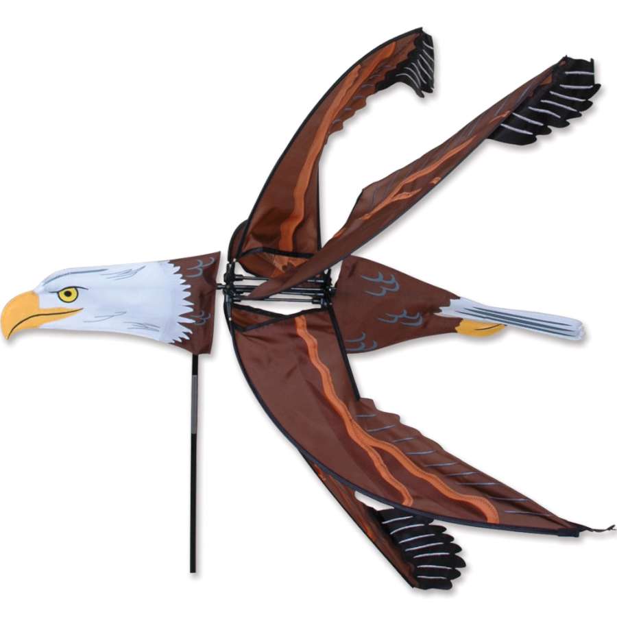 43 in. Flying Eagle Spinner displaying a detailed eagle in flight, beautifully rotating in an outdoor garden setting, symbolizing freedom.