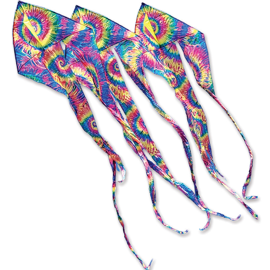 Three 46 in. Flo-Train Delta Kites in tie-dye colors with long colorful tails flying in a clear blue sky at a park setting.
