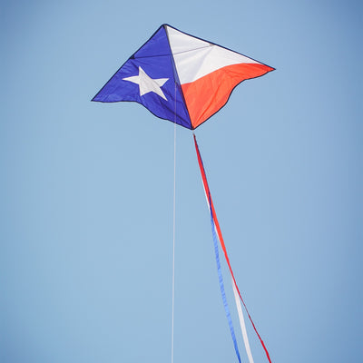 46-inch Texas Delta Kite showcasing a vibrant Lone Star design with colorful 12-foot streamers flying against a clear blue sky.