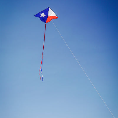 46-inch Texas Delta Kite showcasing a vibrant Lone Star design with colorful 12-foot streamers flying against a clear blue sky.