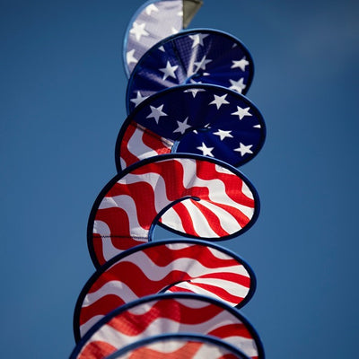 48-inch Stars and Stripes Curlie featuring red, white, and blue graphic dancing in the breeze as a decorative outdoor hanging piece.