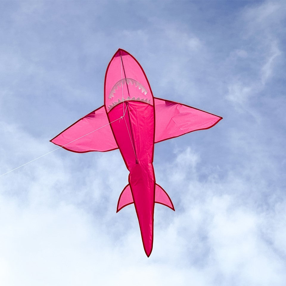 5' 3D Pink Shark Kite soaring against a clear blue sky, showcasing its vibrant colors and detailed design in flight.