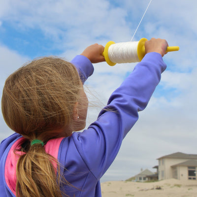 50 LB x 500' twisted kite line on spool featuring durable twisted polyester construction displayed on a colorful plastic spool.