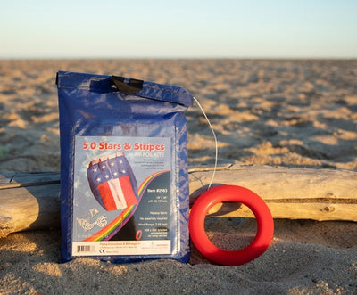 The 5.0 Stars and Stripes Air Foil Kite features vibrant red, white, and blue colors in a stars and stripes design, ready to soar high in the sky with ease.