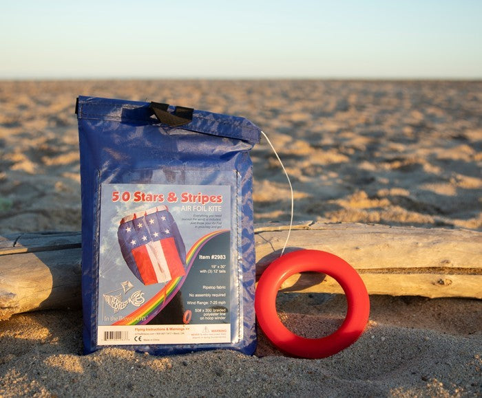 The 5.0 Stars and Stripes Air Foil Kite features vibrant red, white, and blue colors in a stars and stripes design, ready to soar high in the sky with ease.