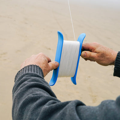 50lb x 500' Twisted Line Breezy WinderTM featuring a durable kite line in aqua color designed for effortless retraction and release, perfect for kite enthusiasts.