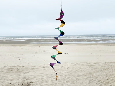 57" Rattlesnake Curlie wind fairy hanging outdoors, displaying vibrant rattlesnake design that spins gently in the breeze.