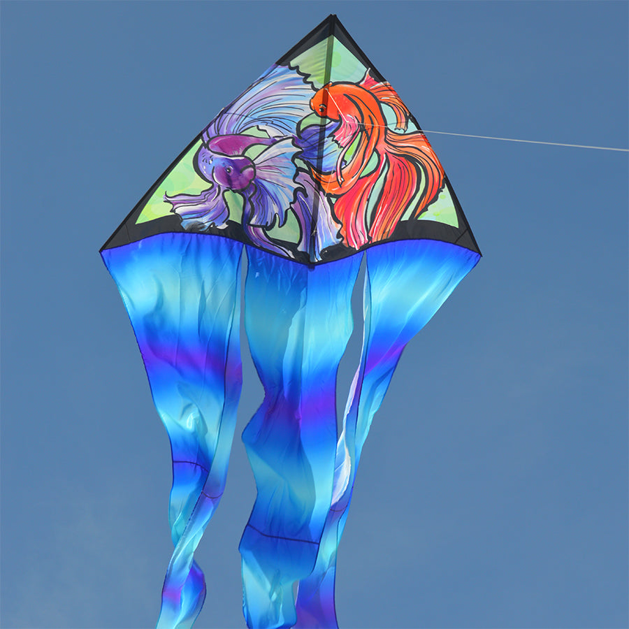 6.5 ft. Flo-Tail Delta kite with long flowing tails flying in a clear blue sky, perfect for outdoor recreational activities.