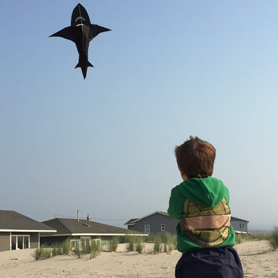 6' 3D Shark Kite with realistic design soaring across a blue sky, featuring tooth-lined jaws and a whipping tail for added excitement.