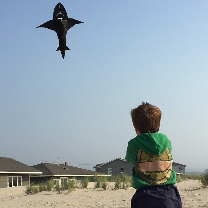 6' 3D Shark Kite with realistic design soaring across a blue sky, featuring tooth-lined jaws and a whipping tail for added excitement.