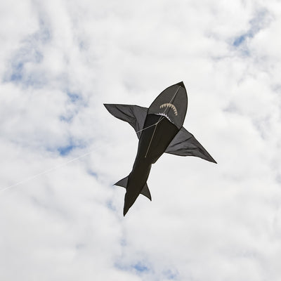 6' 3D Shark Kite with realistic design soaring across a blue sky, featuring tooth-lined jaws and a whipping tail for added excitement.