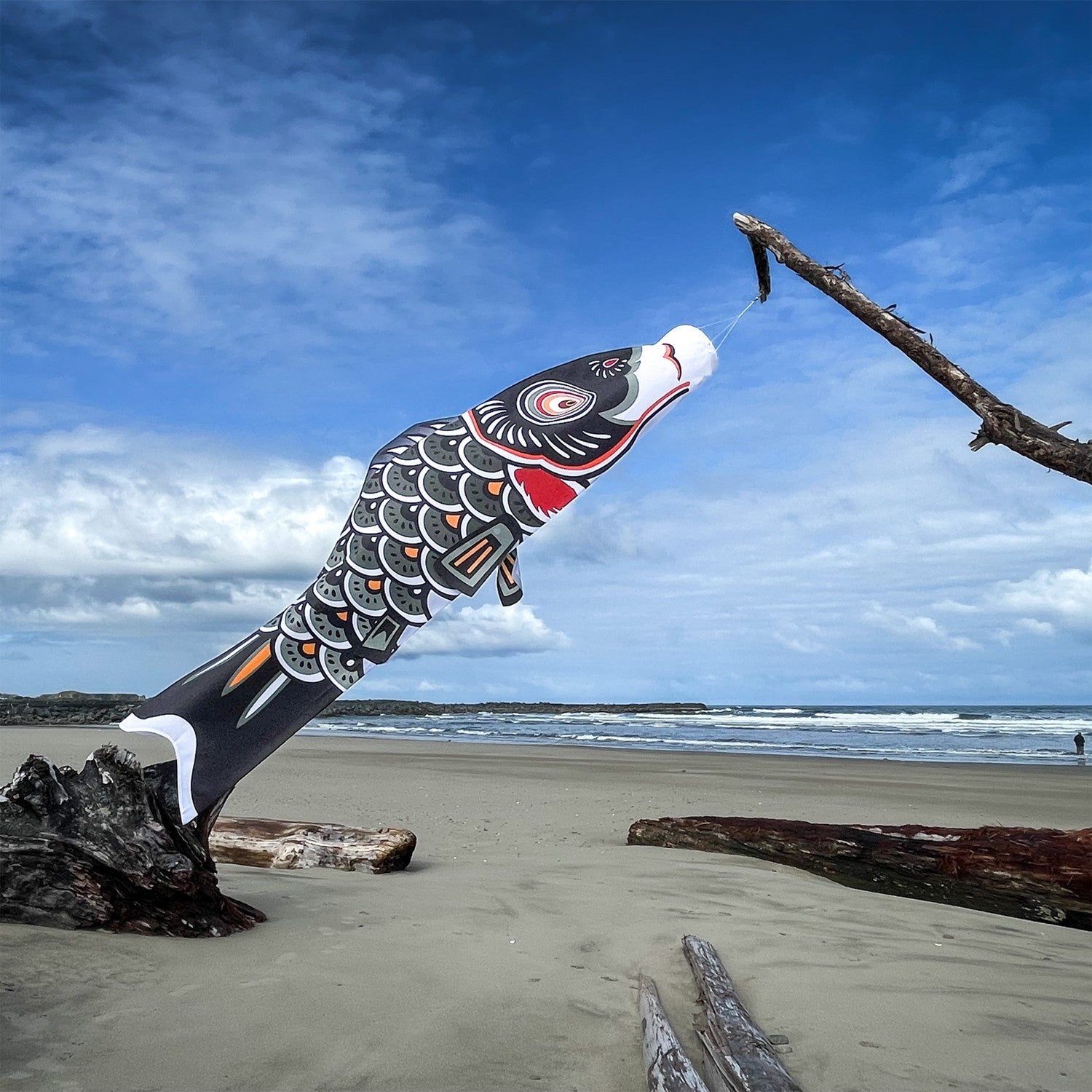 60-inch Black Koi windsock made of durable polyester, featuring vibrant colors and a traditional design, hanging outdoors in a breezy garden.