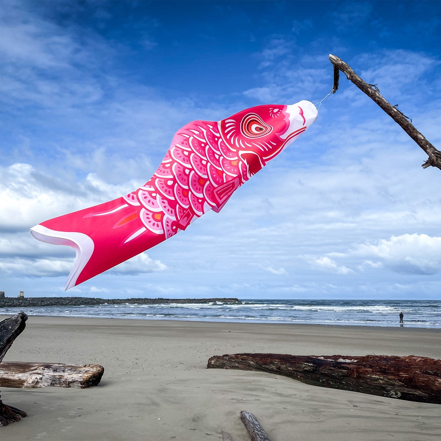 60-inch Pink Koi windsock with beautiful detail, displayed gracefully in an outdoor garden setting, adding color to the space.