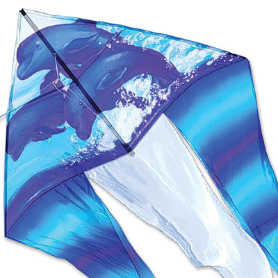 6.5 ft. Flo-Tail Delta Kite in a dolphin design soaring in a clear blue sky with long flowing tails showcased in a park setting.
