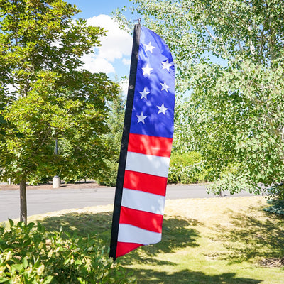 7-foot Embroidered Stars & Stripes Feather Banner featuring bold colors and embroidered stars displayed prominently outdoors at an event.
