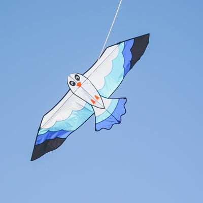 70-inch Blue Seabird Kite featuring a vibrant design and felt details soaring against a clear sky, ideal for outdoor flying adventures.