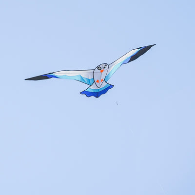 70-inch Blue Seabird Kite featuring a vibrant design and felt details soaring against a clear sky, ideal for outdoor flying adventures.
