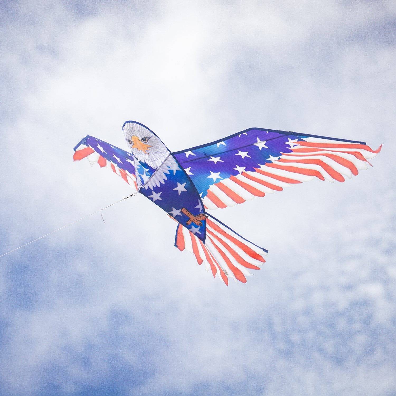 70-inch Patriotic Bald Eagle Kite soaring in the sky, featuring a majestic bald eagle design and American flag patterns against a blue backdrop.