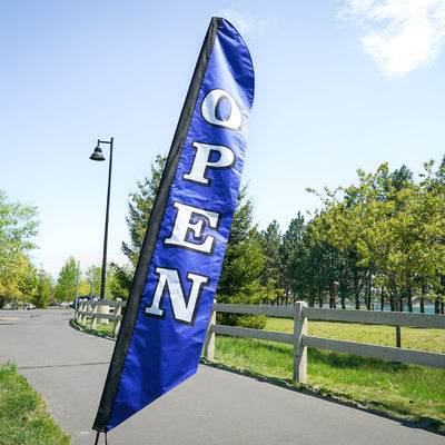 8' Heavy Duty Open Navy Double Sided Feather Banner displayed outdoors, showcasing bold 'OPEN' text designed for visibility and durability.