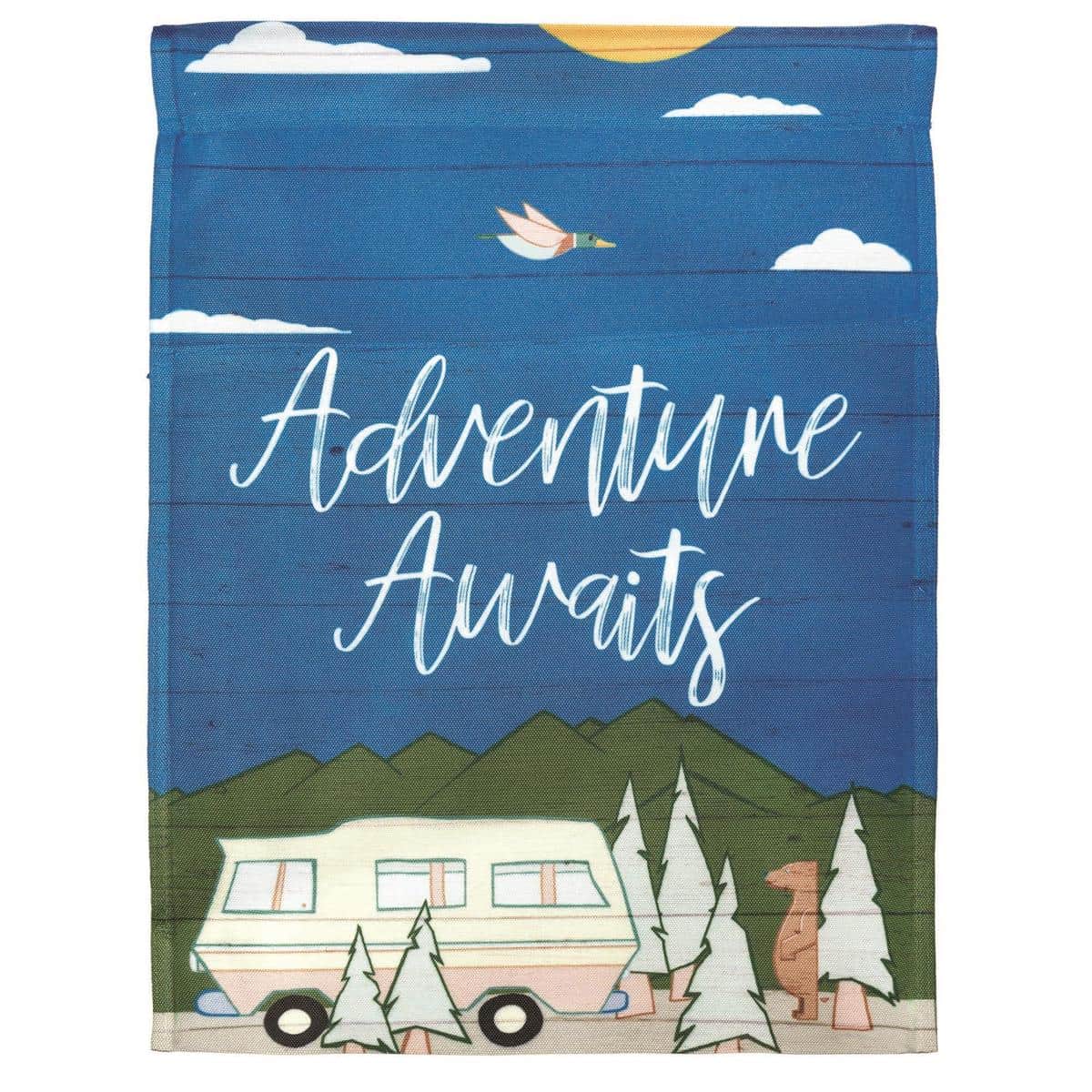 13x18 Adventure Awaits printed garden flag with mountains, compass, and inspirational lettering displayed on a metal garden pole in a sunny front yard.