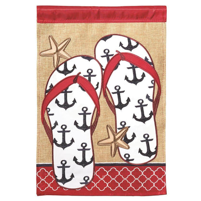 Anchor Flips 29x42 double applique burlap house flag showing layered anchor and flip flops, coastal textures, reinforced stitching, top sleeve fits standard poles