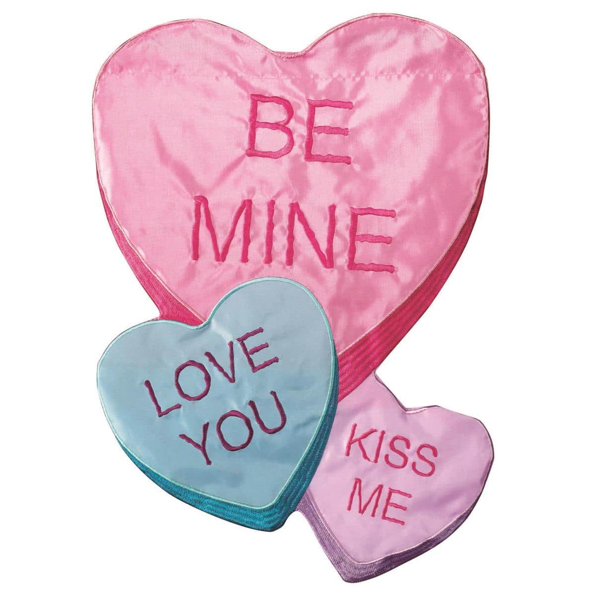 Alt text: Close-up of Be Mine Candy Hearts 13x18 garden flag on a metal garden stake showing layered heart appliques, bold 'Be Mine' lettering, and vivid red, pink, and cream colors against a porch background.