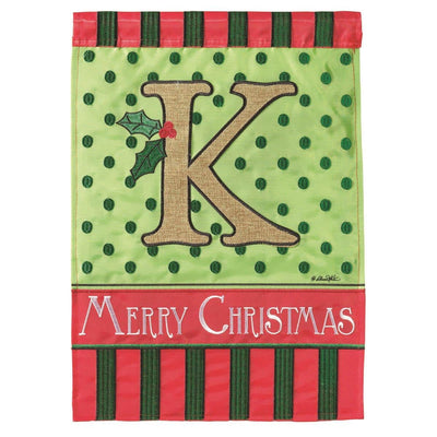 13x18 burlap Christmas monogram K garden flag with double applique holly accents displayed on a yard flag stand for porch or garden seasonal decor