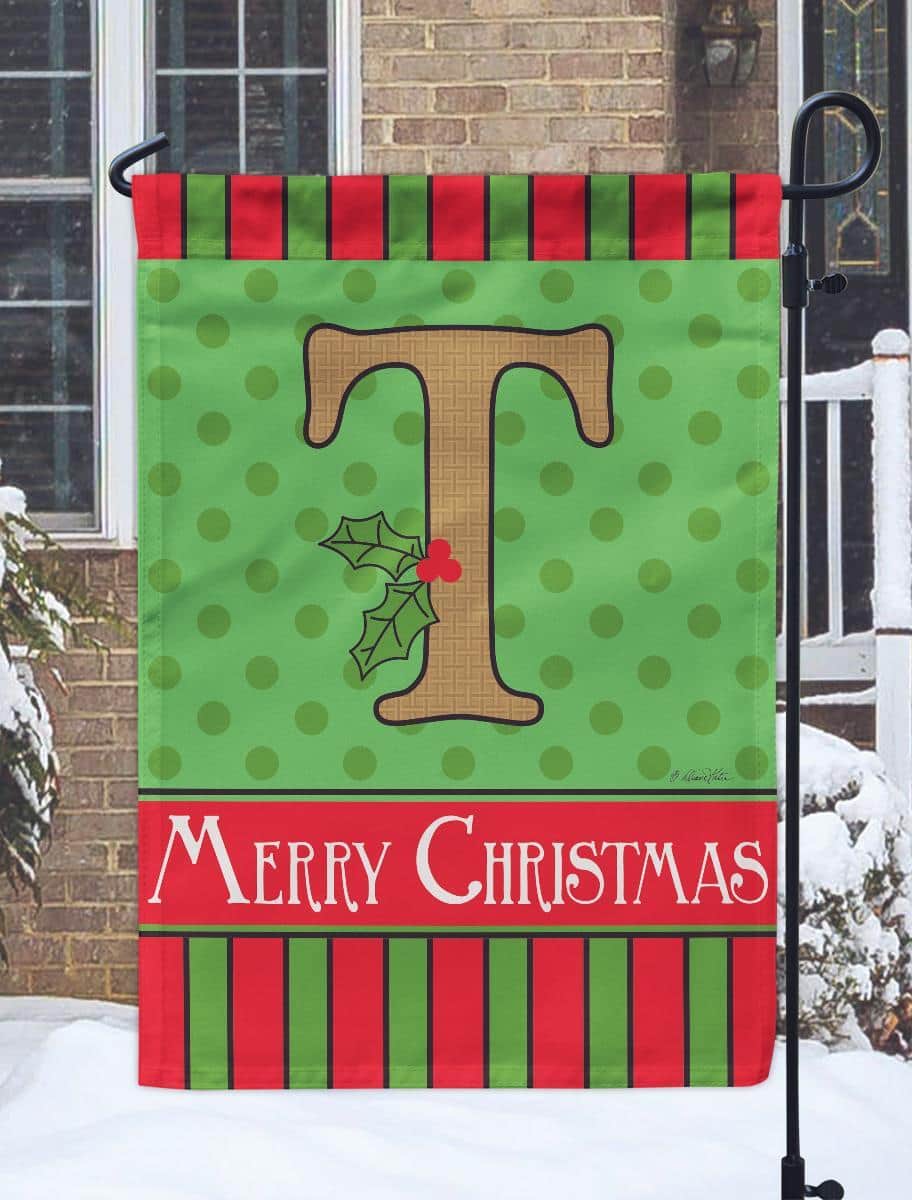 13x18 Christmas Monogram T garden flag with burlap background, double applique monogram T, holly and pine accents, shown on a metal garden flag stand at a festive porch display.