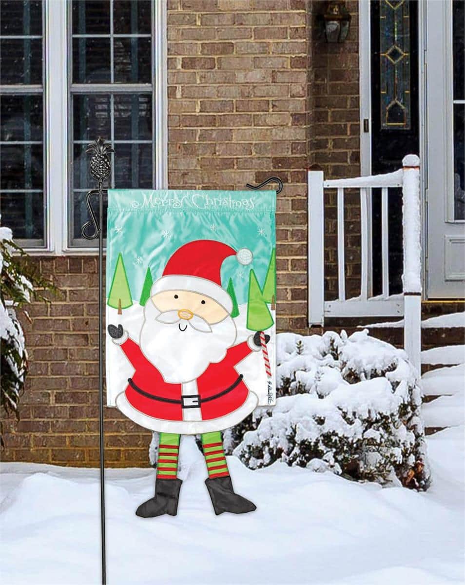 Alt text: 13x18 Crazy Leg Santa Christmas garden flag with whimsical long-legged Santa in festive colors displayed on a front yard flag pole.