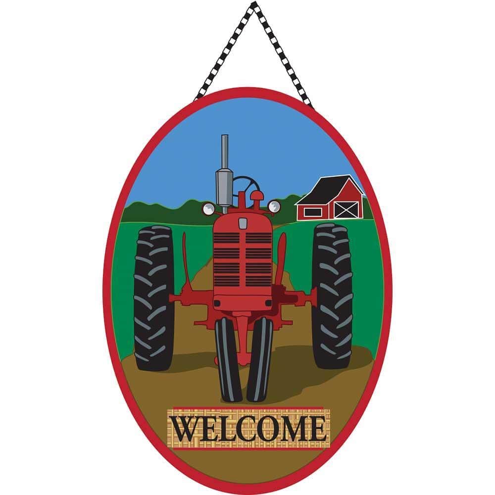 Close-up photo of rustic burlap door banner featuring a red tractor illustration and the word Welcome, displayed hanging on a farmhouse front door with natural trim.
